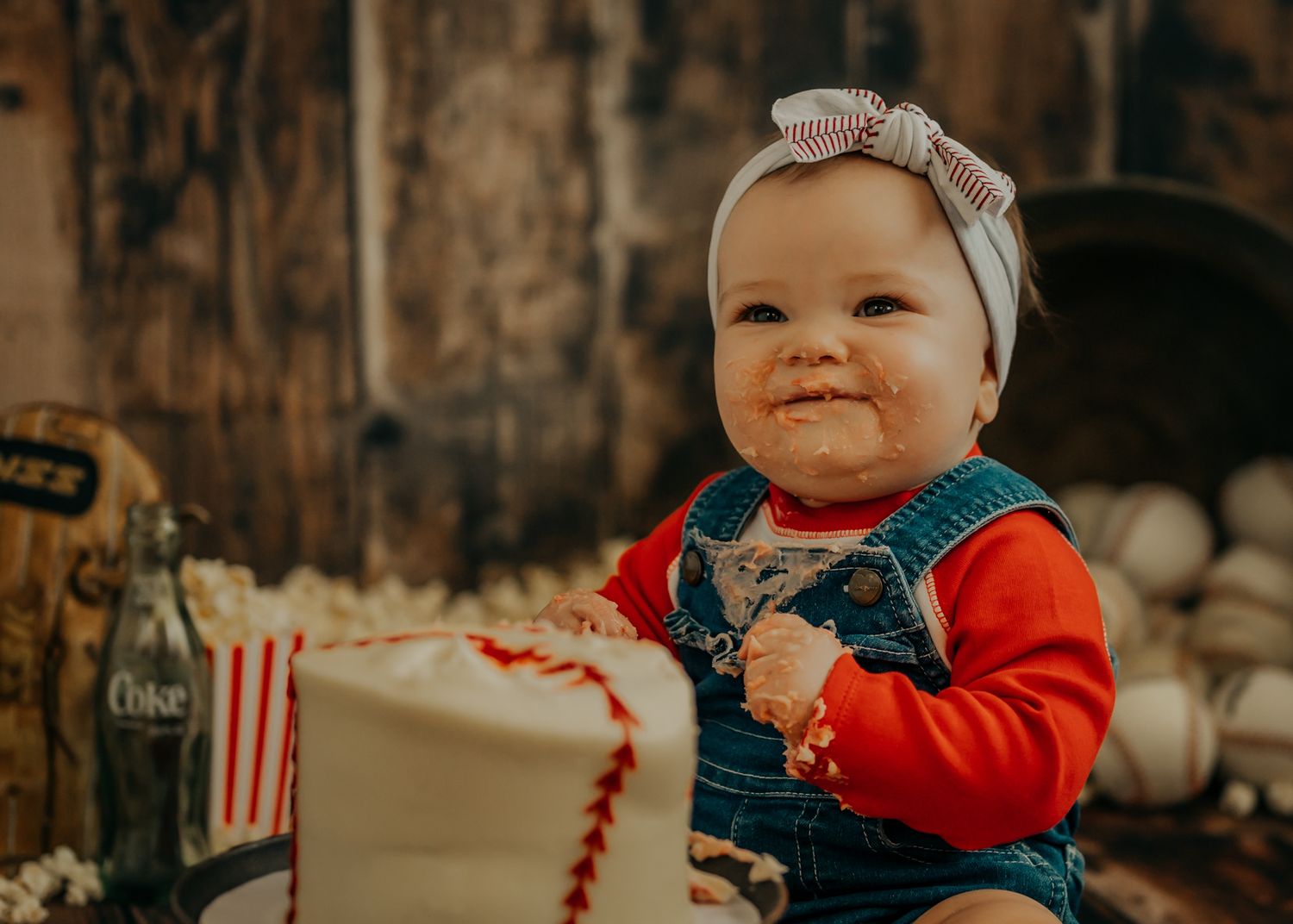 Little lady showing off her bubbly personality during first birthday photoshoot. Pink and cow print color scheme.
