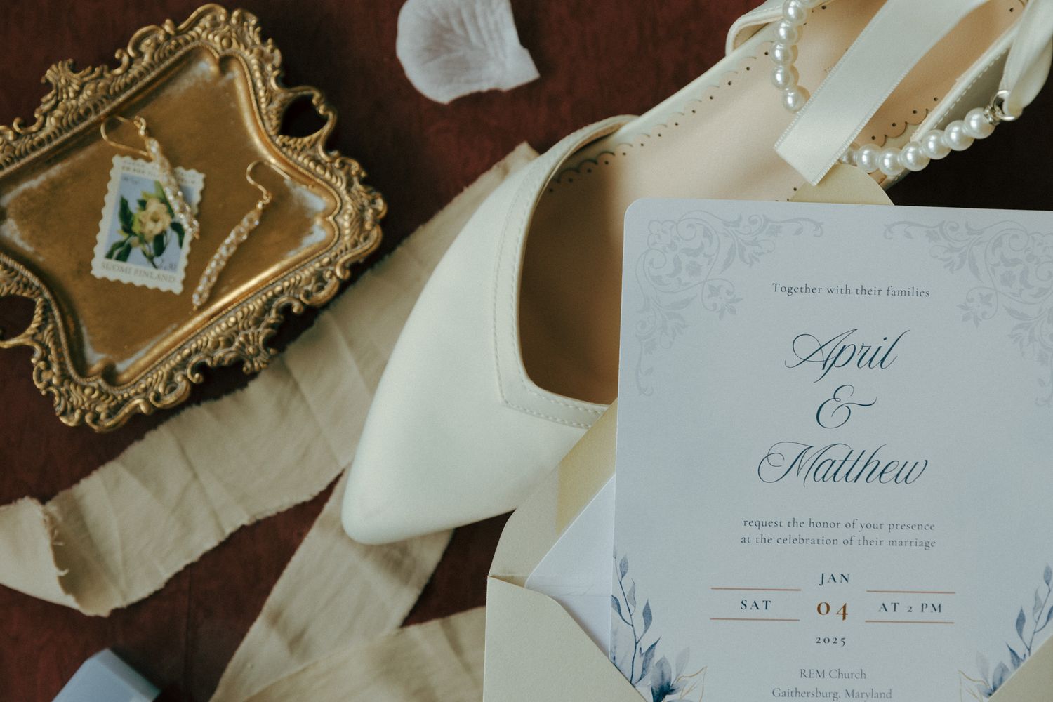 Elegant wedding stationery and white heels with ornate gold frame detail.