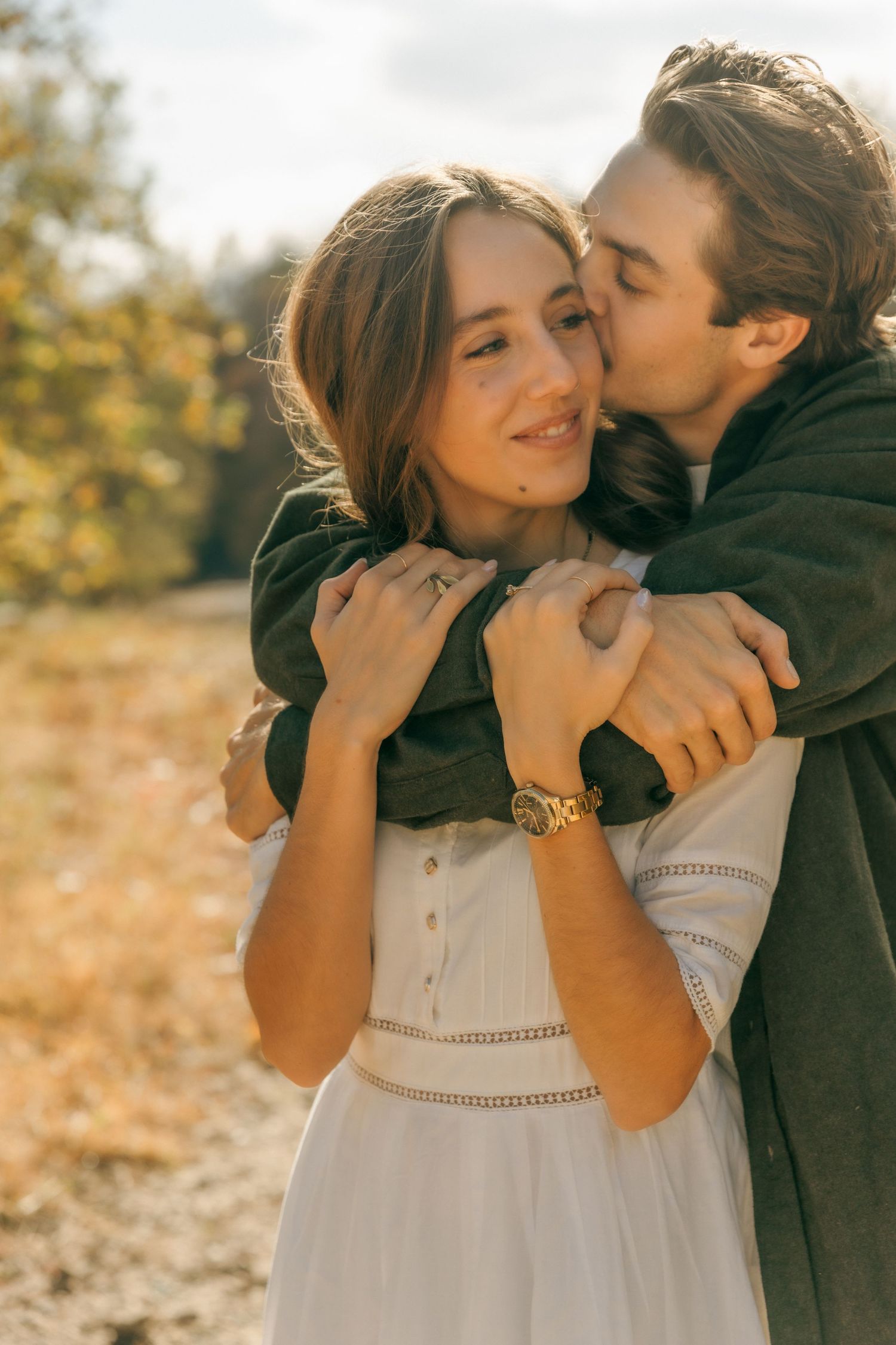 A tender autumn embrace captured in warm sunlight.