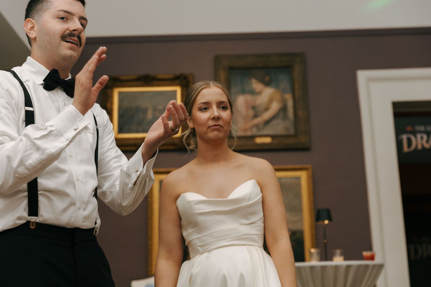 Wedding reception scene showing celebration moment at an art gallery venue.