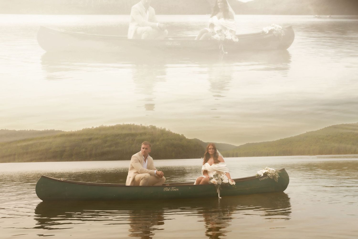 Dreamy sunset photo of newlyweds in a canoe on a tranquil lake.