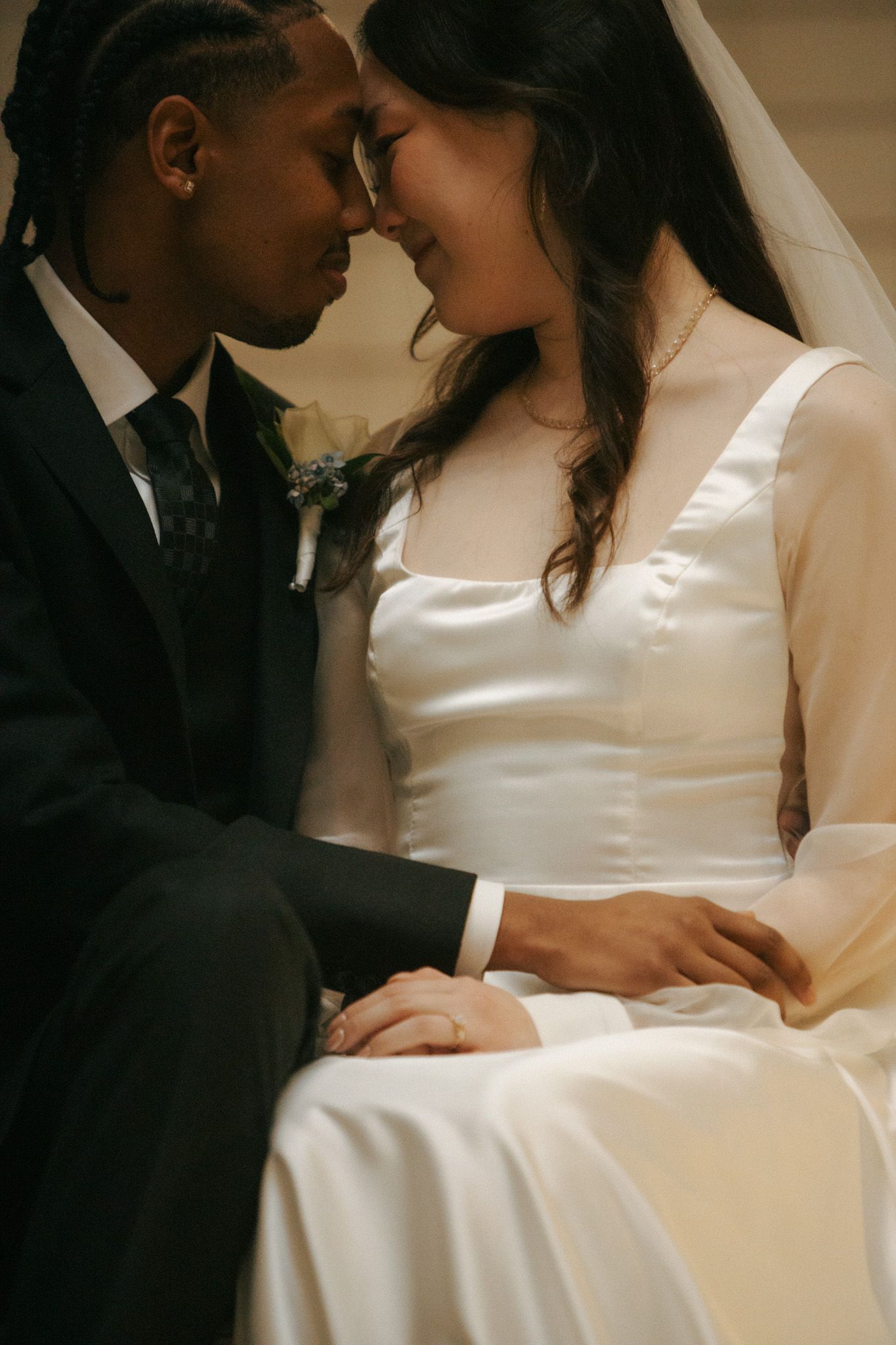 Intimate moment between newlyweds sharing a tender embrace.