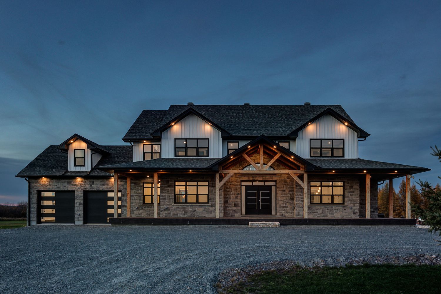 Modern ranch house with stone facade and multiple dormers captured in panoramic view.