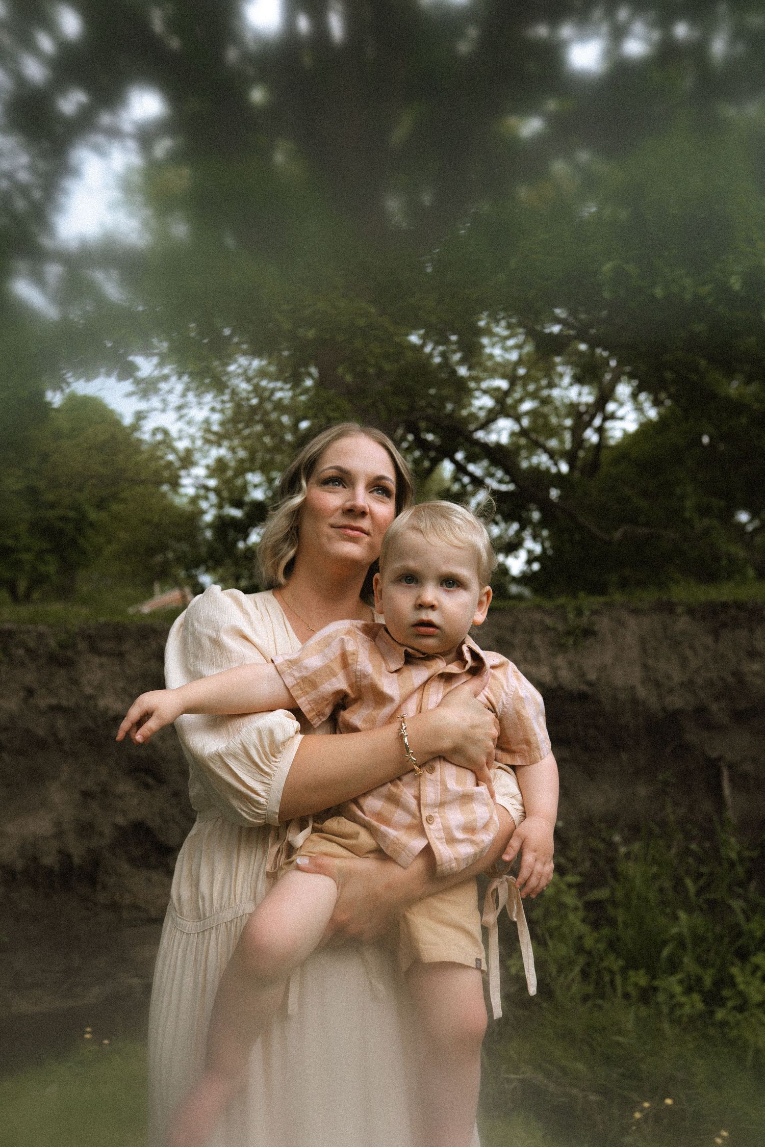 A dreamy outdoor portrait of parent and child in light colored dresses.