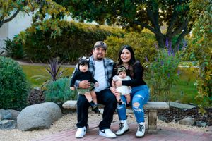 Family photos taken in outdoor garden setting with trees and greenery.