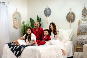 Casual family moments captured during holiday photoshoot with Christmas decorations and natural light.