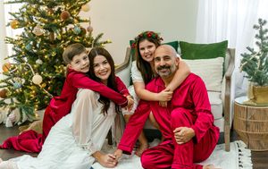 Candid holiday photos of a family in red and white outfits posing by their Christmas tree.