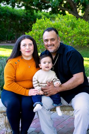 Family photos on brick pavers featuring casual outfits and natural garden background.