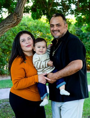 Family portrait session in a park with casual attire and natural lighting.