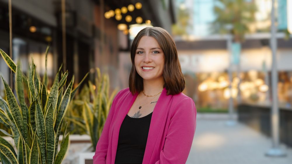 Professional headshot of woman in front of building in Tampa, FL.