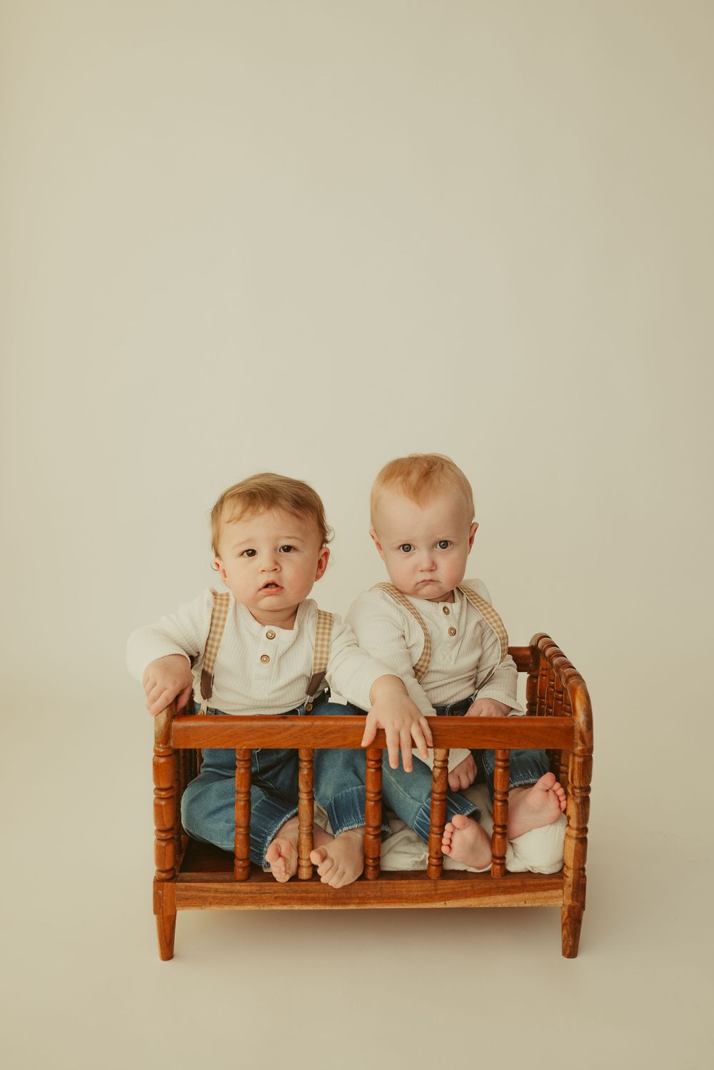 Twin baby boys in wooden crib from Luneberry, spindle crib newborn prop shown in use. Photo by Disney Magic Photography Clarksville, TN.