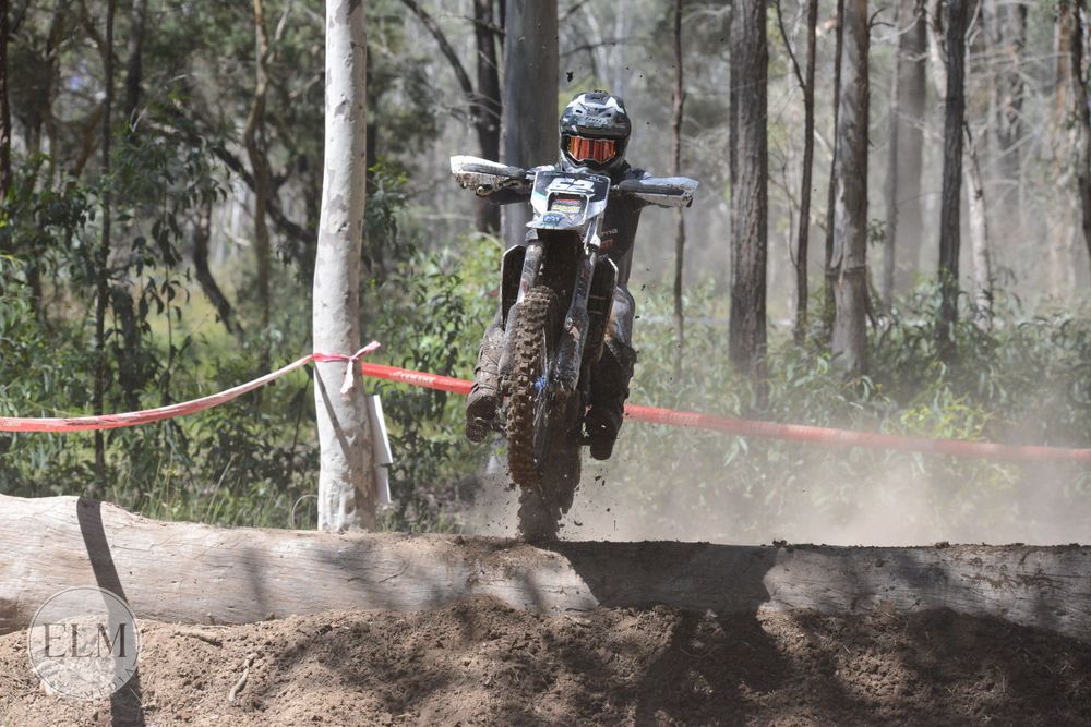 Motorbike jumping a log