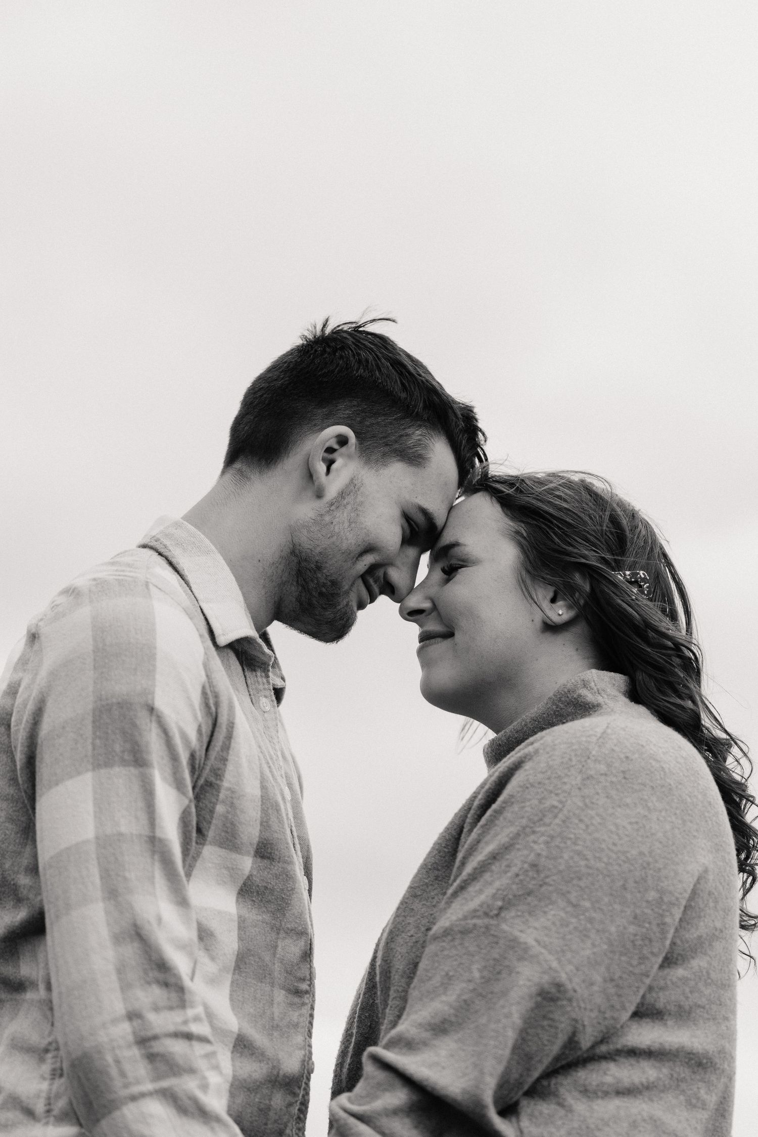 Intimate black and white couple portrait series showing tender romantic moments.