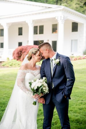 Romantic wedding portraits taken on the lawn of a white colonial style building. Farmington Polo Club CT
