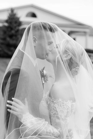 Artistic black and white wedding portraits captured through a flowing bridal veil. Farmington Polo Club CT