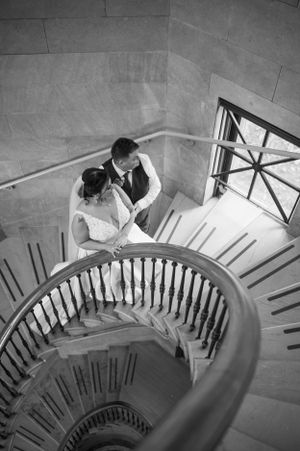 A spiral staircase wedding photoshoot captured from above in black and white. Blackstone Library Branford CT