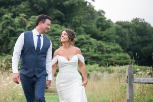 Newlyweds sharing a romantic moment in a sunlit meadow.