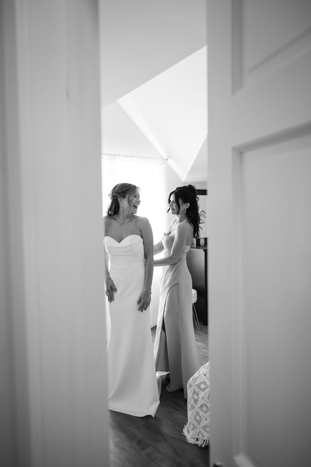 Bride and her Maid of Honor getting ready in bright white minimalist space. Kalmia Garden at Gastler Farm