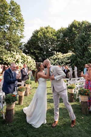 A couple shares a kiss after their ceremony Kalmia Garden at Gastler Farm