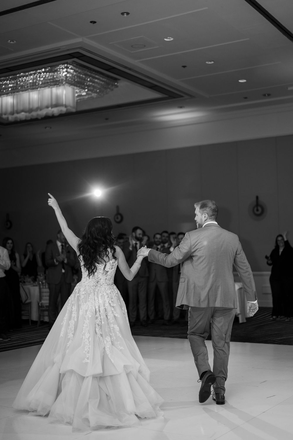 Dancing couple in formal attire on illuminated ballroom floor during celebration. Hyatt Regency Greenwich Connecticut