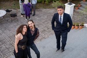 couple and friend posing on staircase on wedding photography