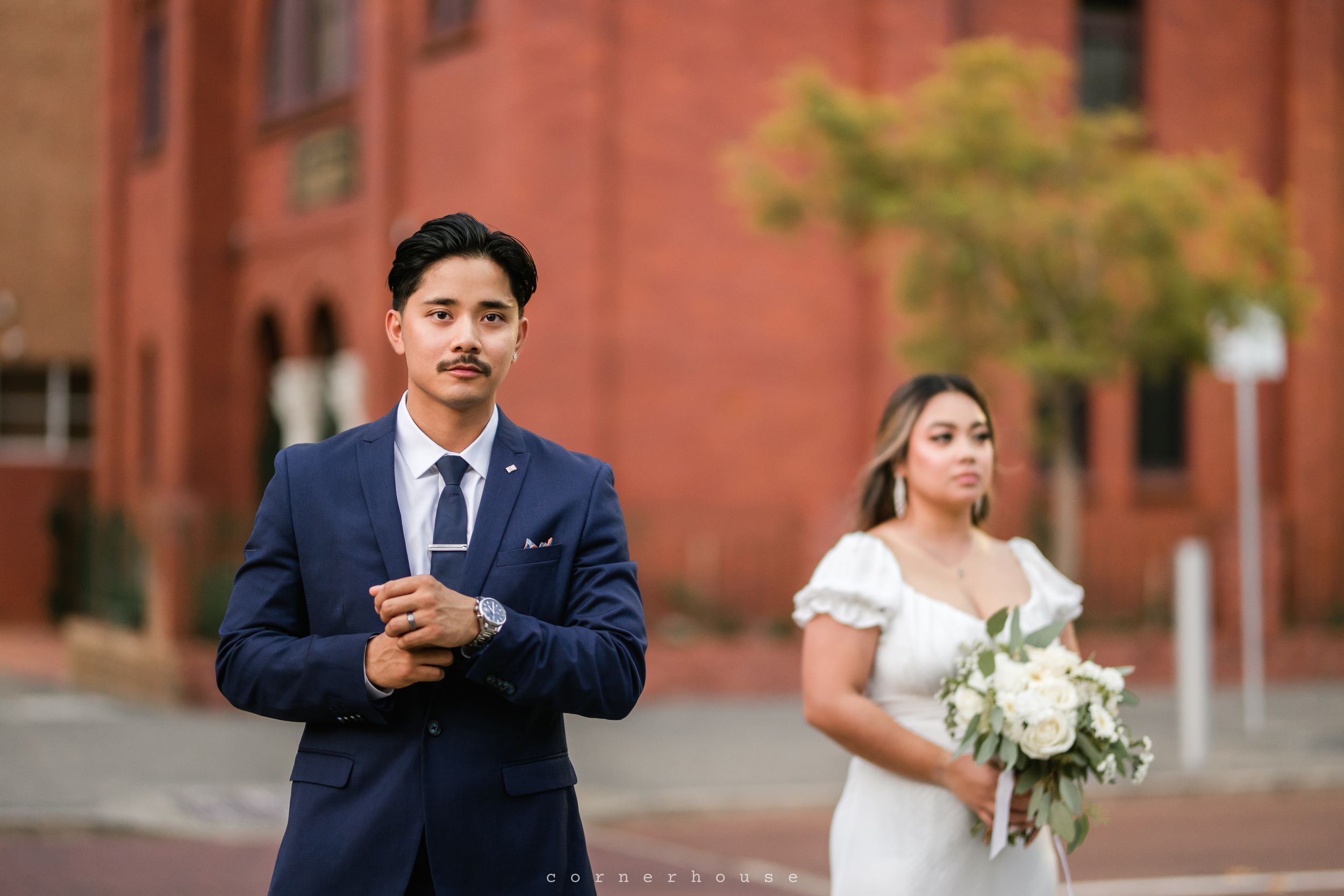 Brick wall backdrop wedding photo sequence showing interactions between newlyweds in formal attire.