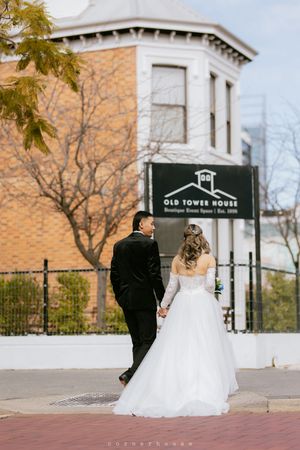 Four wedding photos showing a couple posing together outside a historic building, highlighting the bride's flowing white dress.