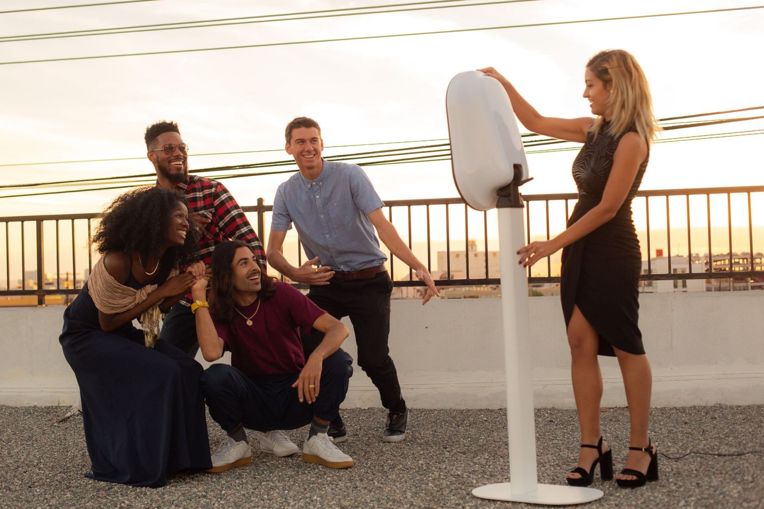 Behind the scenes photo shoot setup with lighting equipment and crew outdoors.