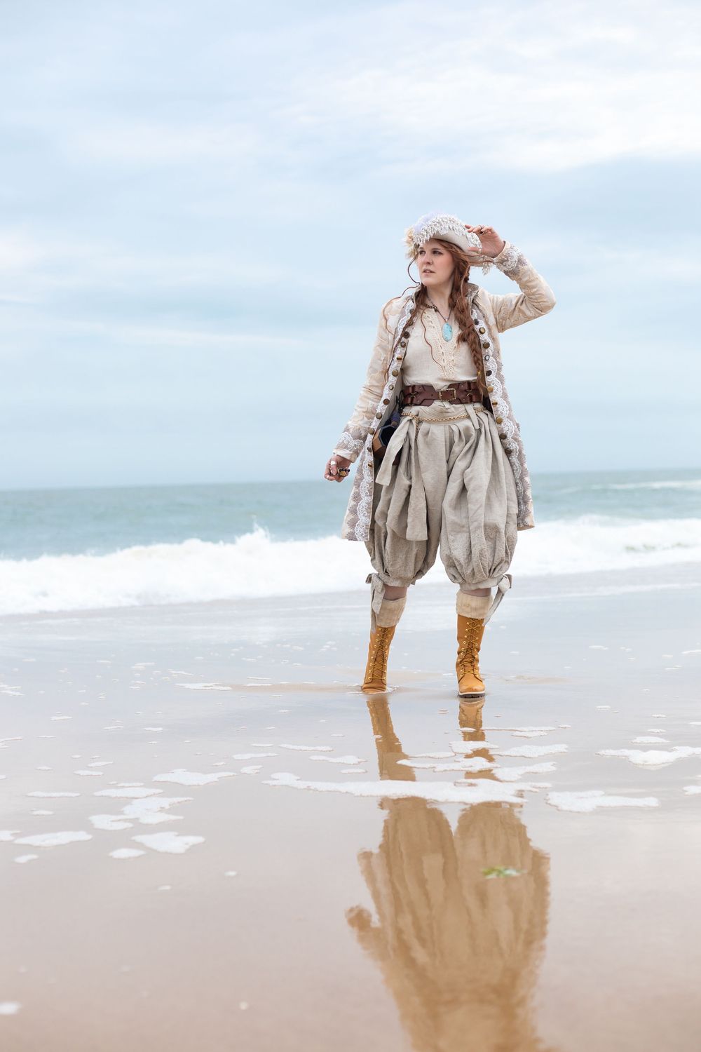A pirate stands in the shallow water