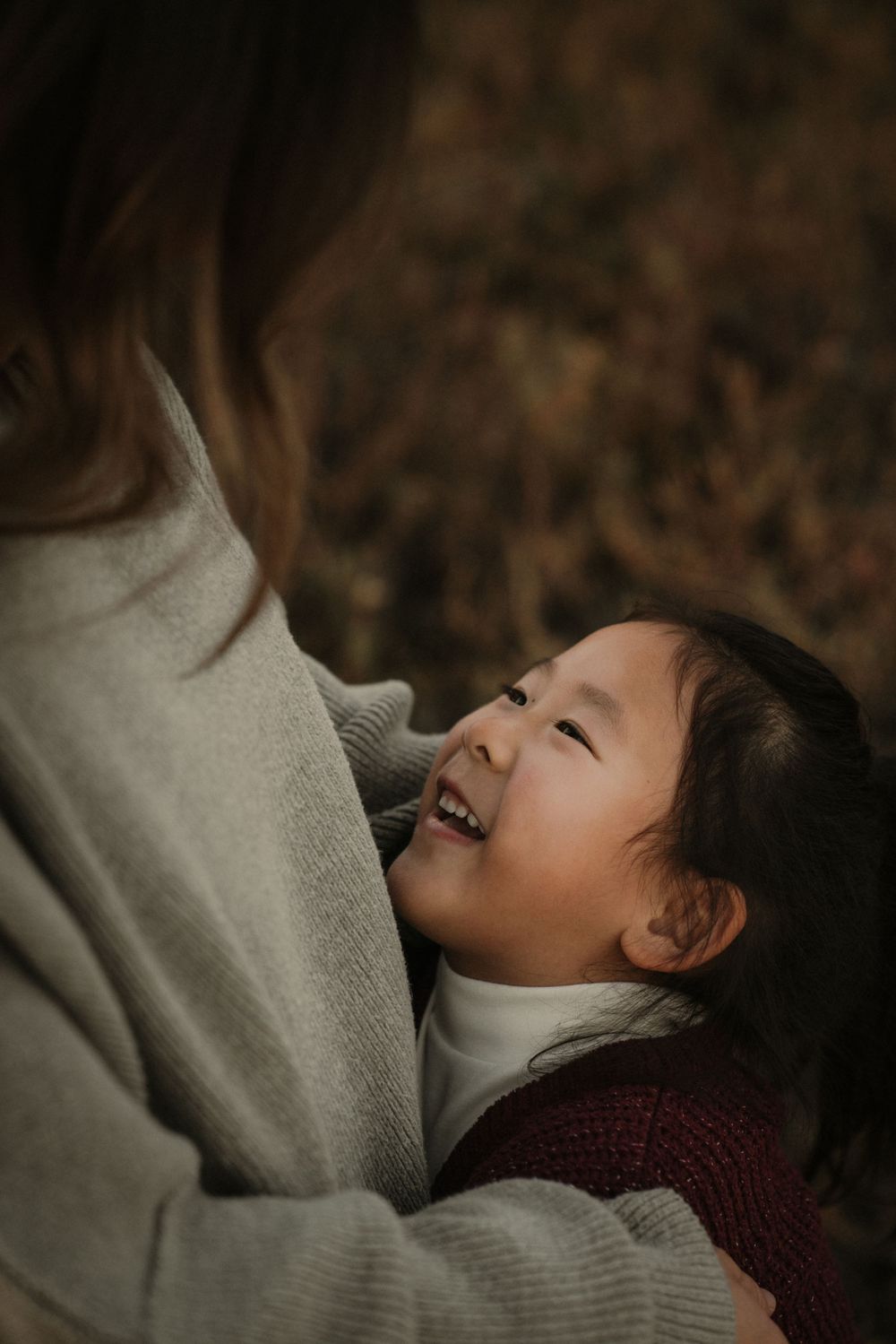 A heartwarming candid moment showing affection and laughter in warm evening light.