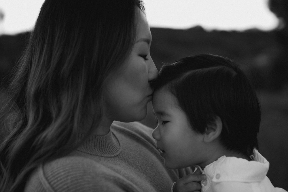 An intimate black and white portrait capturing a tender moment of connection.