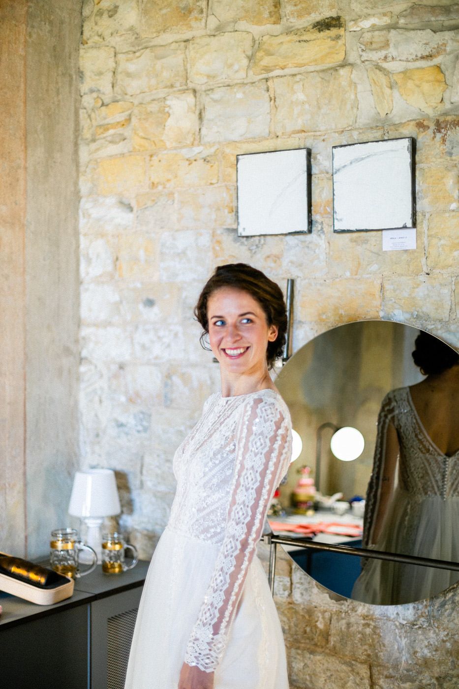 Elegant bridal preparation room with stone walls and vintage mirror setup.