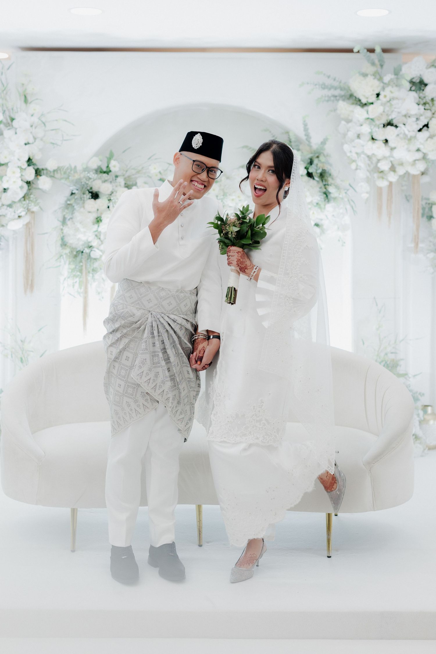 Close-up portrait shot with soft focus white flowers in the foreground creating a dreamy romantic atmosphere.