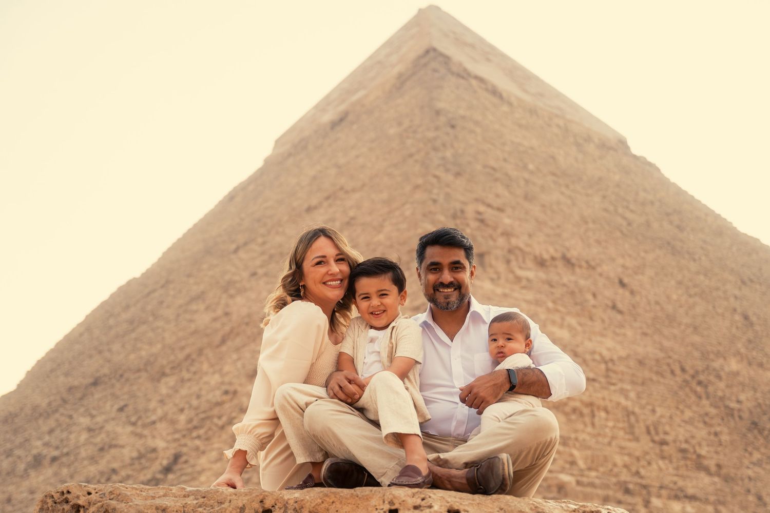 Tourists view the iconic Great Pyramids of Giza from multiple angles in a series of black and white photographs.