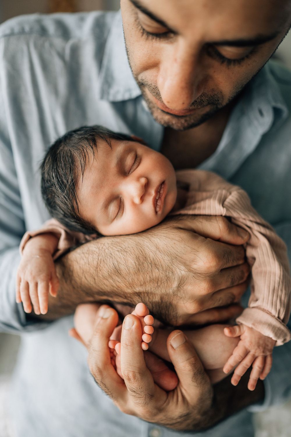 dad holding his newborn baby on his chest during dubai photography shoot