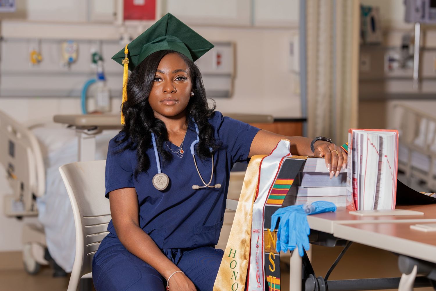 Graduate sitting on concrete steps wearing academic regalia and Air Jordan sneakers.