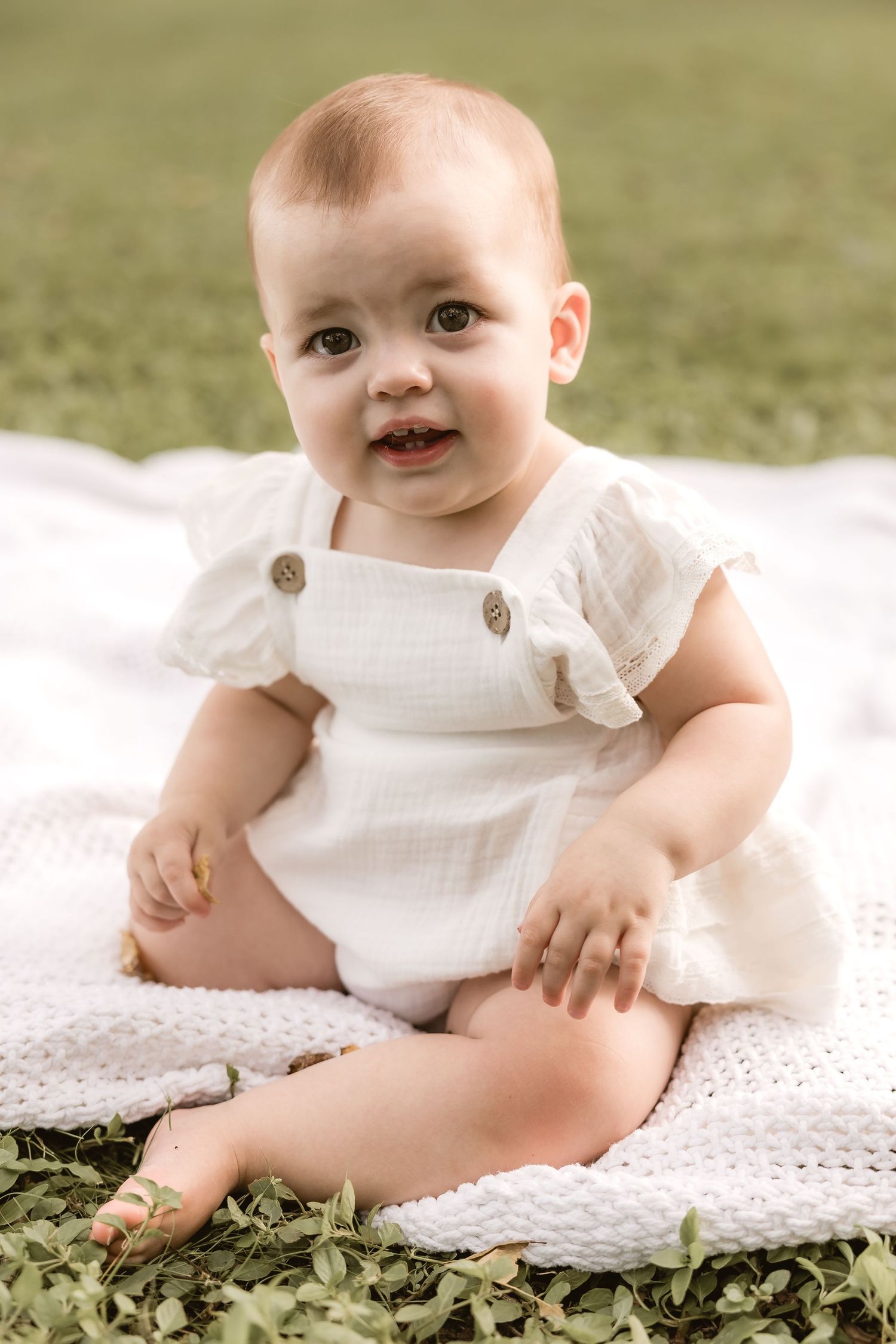 Mother dressing baby for a portrait shoot in their Brisbane home