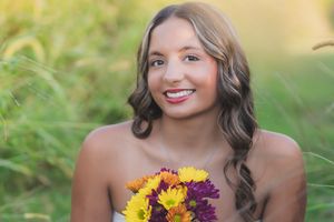 Summer portrait with vibrant sunflowers and purple flowers against a soft bokeh background.