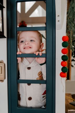 A creative collage of window frames with festive red and green ornaments and decorative elements.