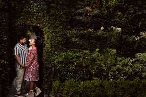 Couple standing together in a lush green garden archway, sharing a romantic moment outdoors.
Summerville/Charleston, SC