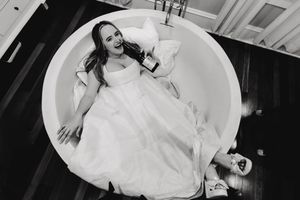 A series of black and white photos showing a bride's flowing white dress as she moves and twirls in graceful positions.