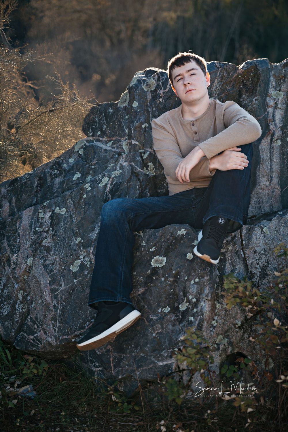 Gunner posing on rock for senior photo session