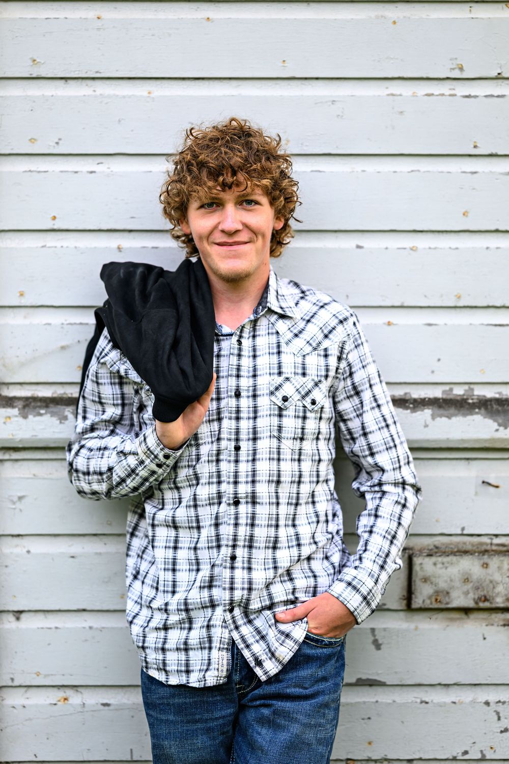 Levy senior boy on white barn background
