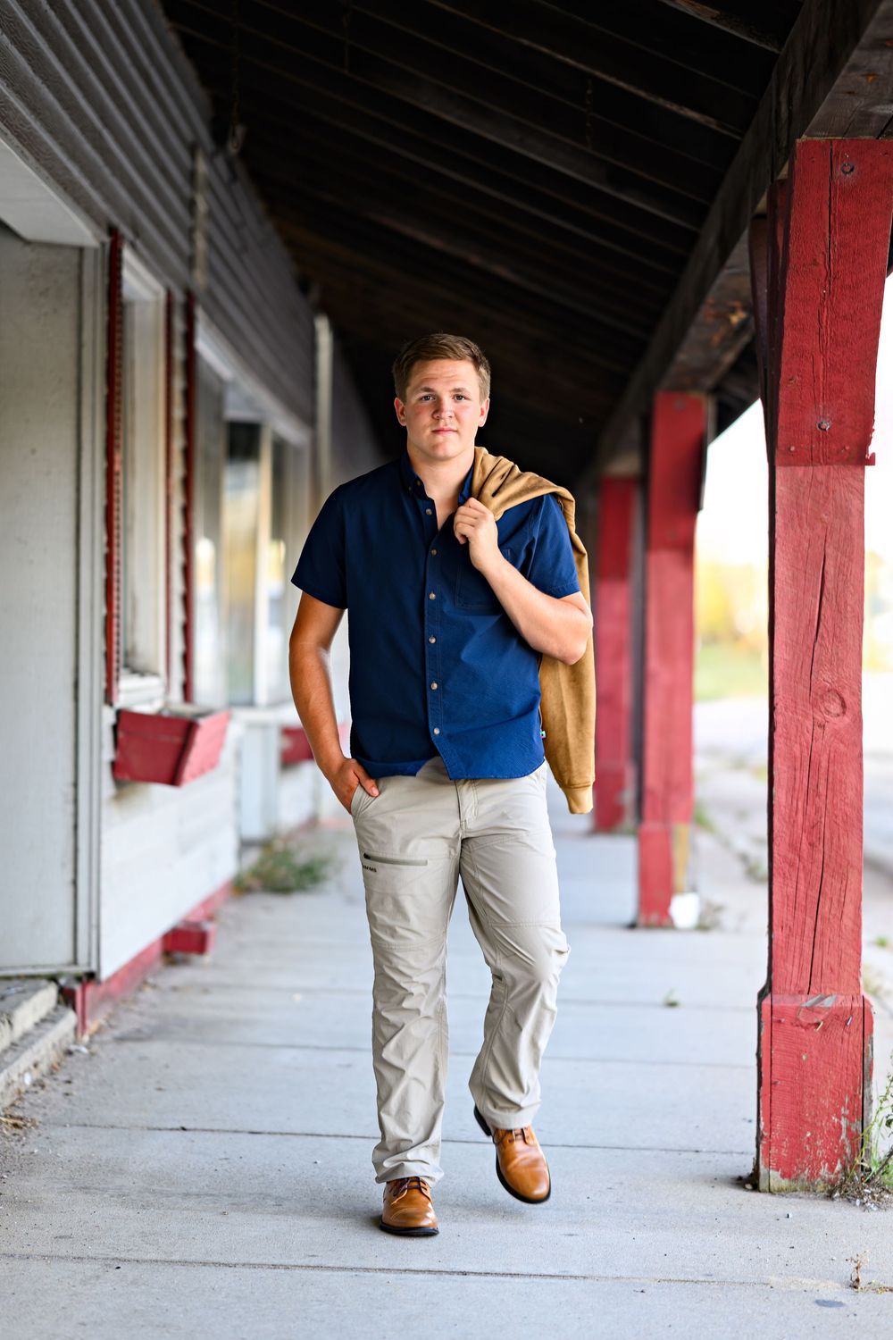 senior photography boy walking on sidewalk Orr, Minnesota