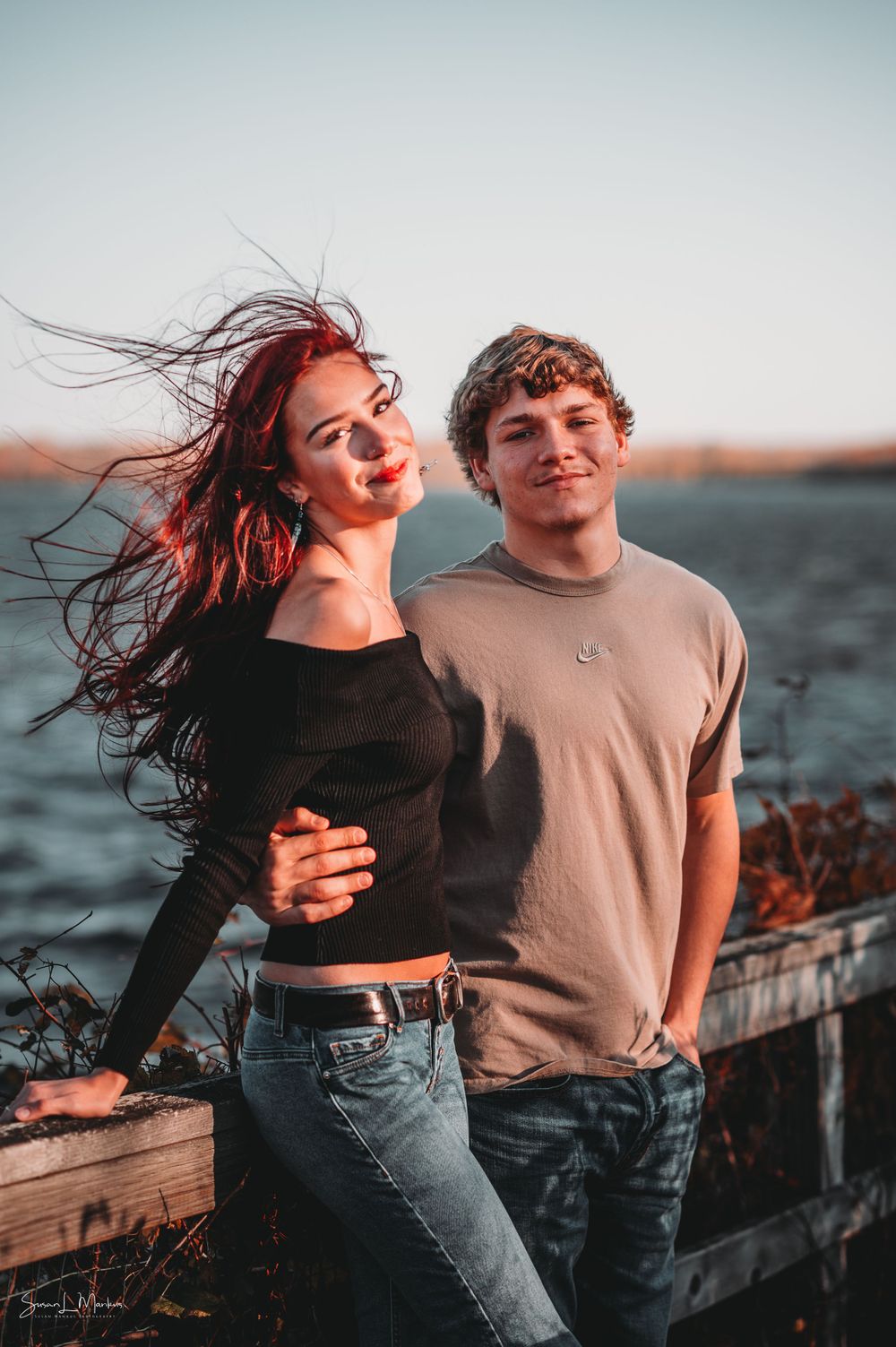 Young couple on dock with lake background