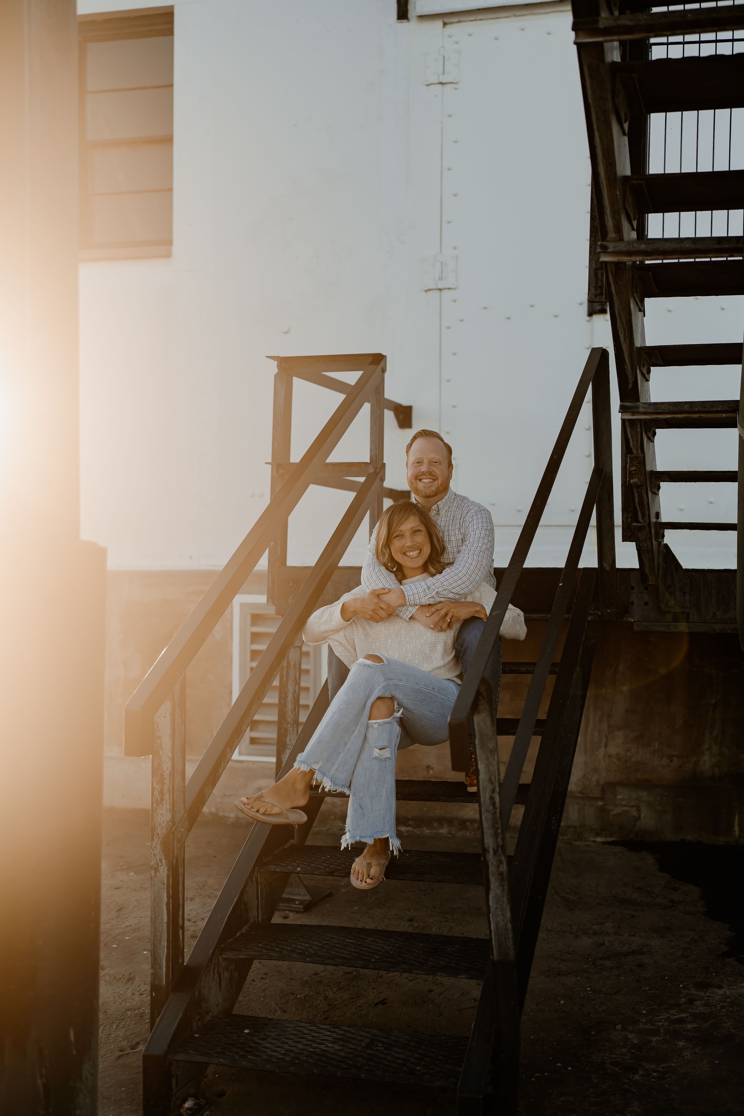 A person sits on dark wooden stairs in a series of four progressive photos with warm lighting.