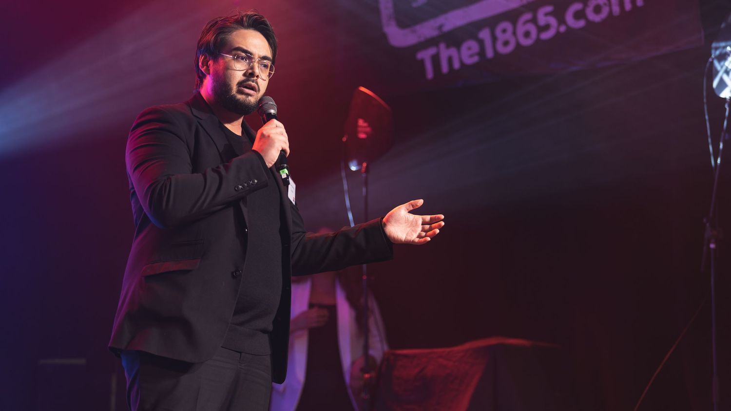 Singer performing on stage at The 1865 venue Southampton with dramatic lighting, live music event photography