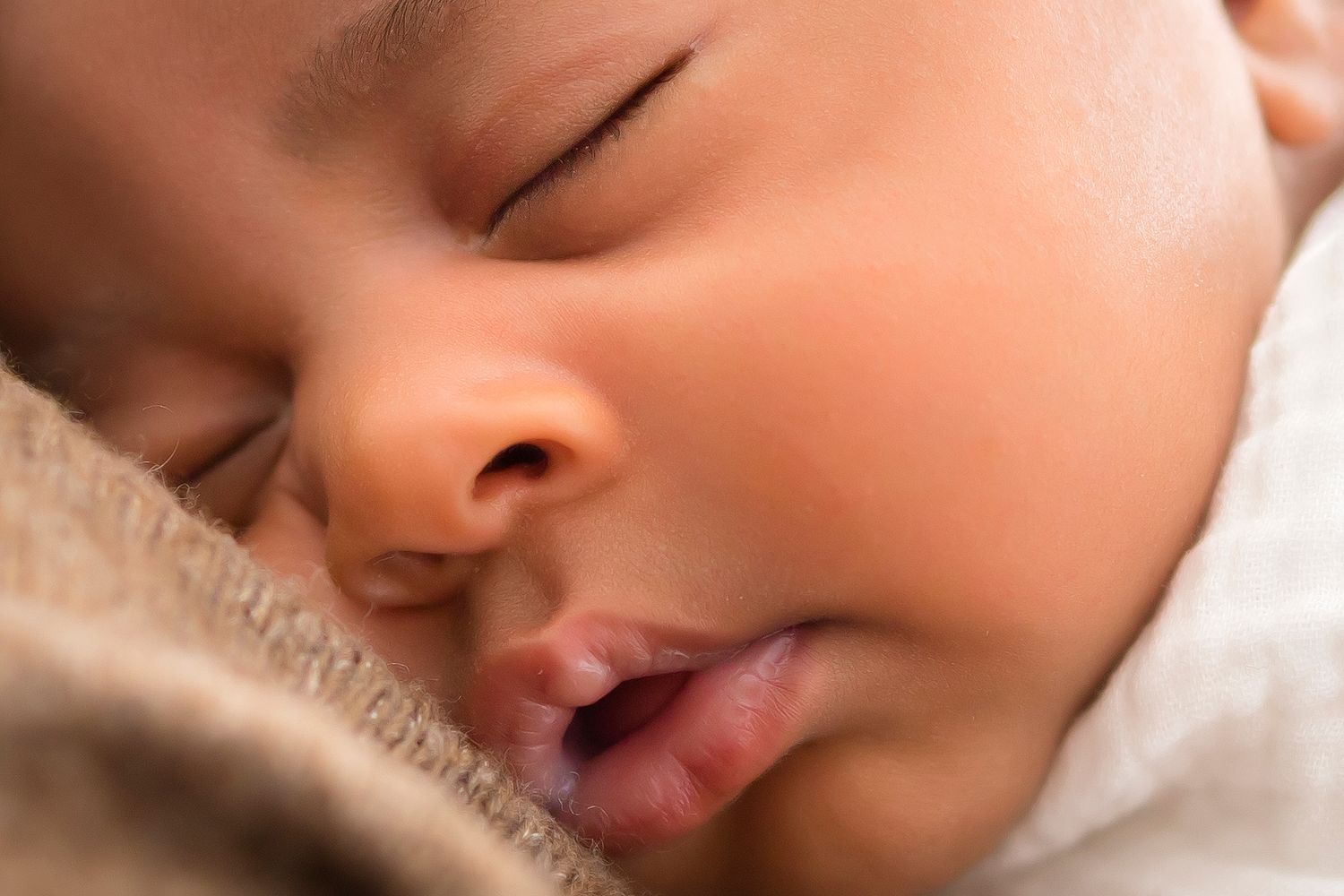 Close up of baby girls face, she is sleeping, focus on facial features