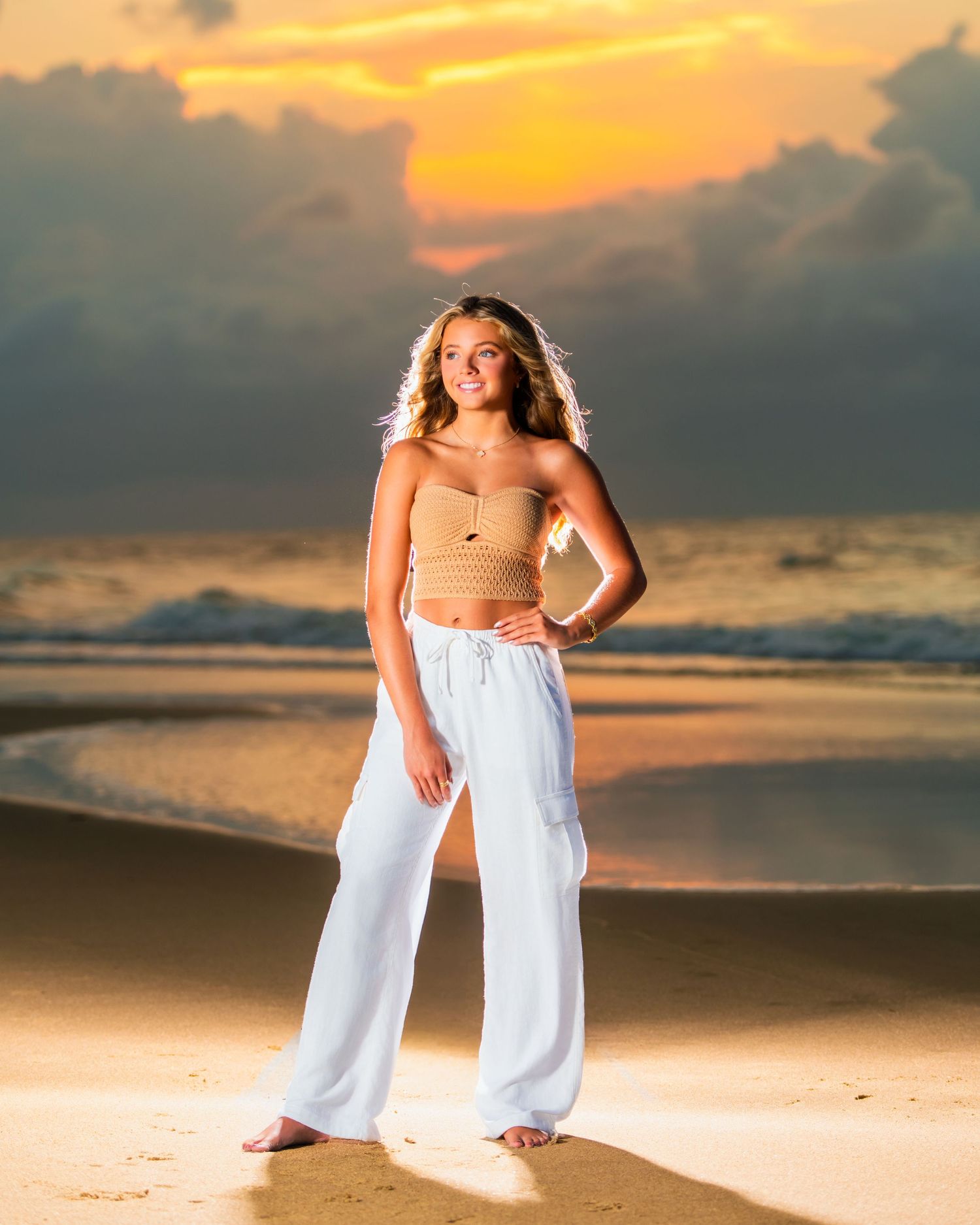 Beach portrait with golden sunset lighting and warm tones on sandy shore. Myrtle beach photographer