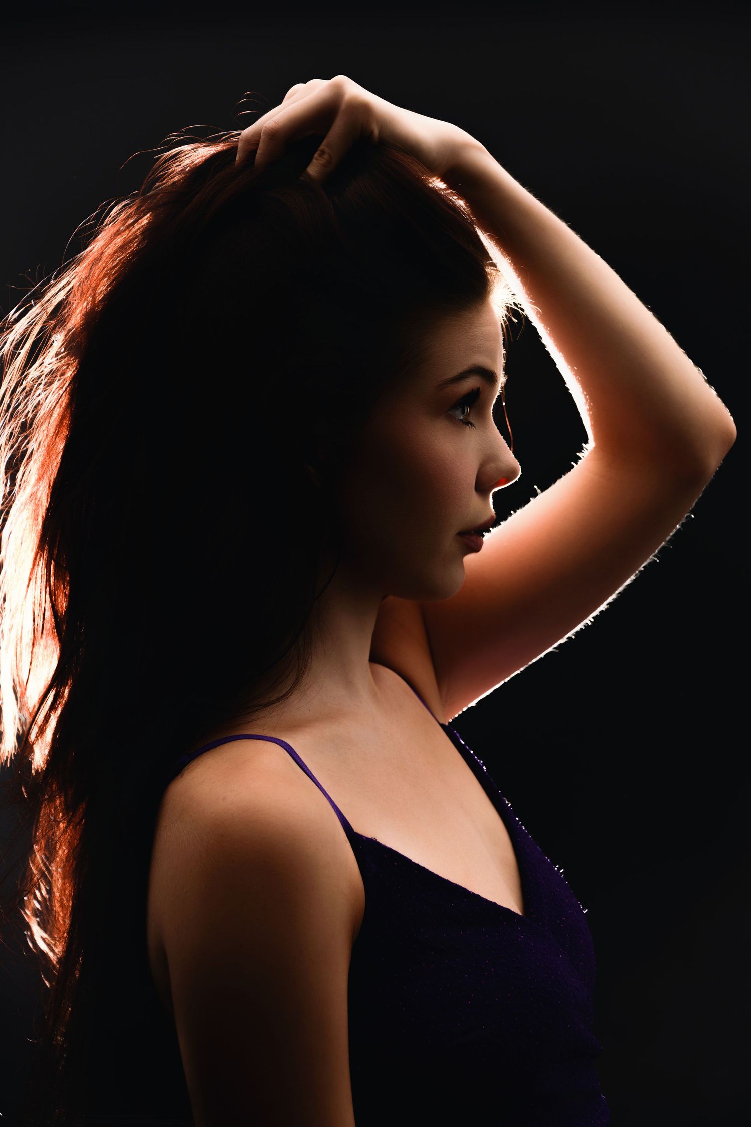 Artistic silhouette portrait showing dramatic lighting and shadows against a dark background. myrtle beach photographer